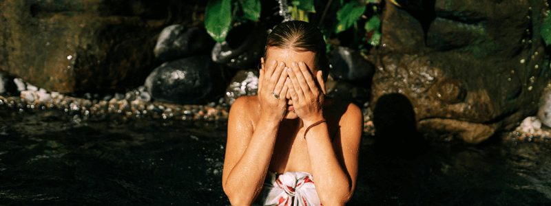 woman bathing in a natural pool